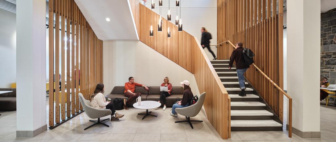 Students walk up the stairs in the university center.